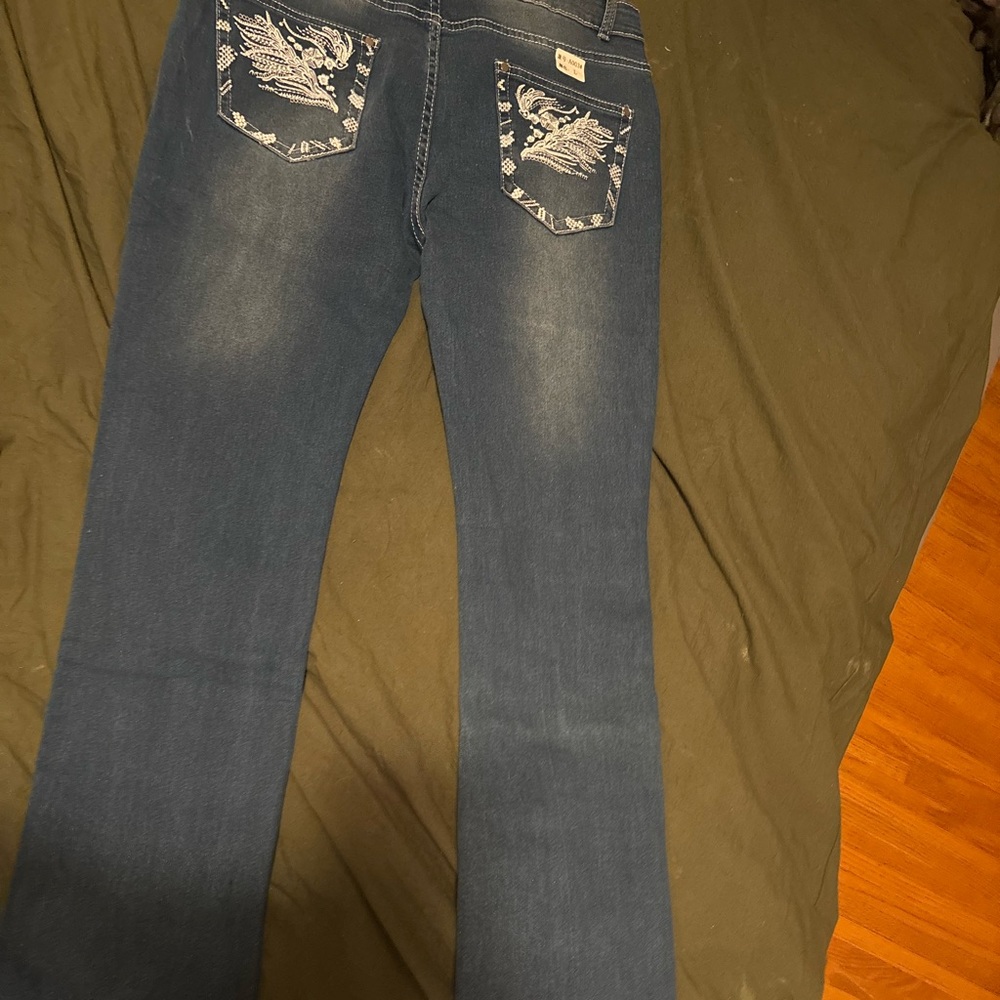 Brand new never been worn designer jeans with embroidered pockets and flare fit